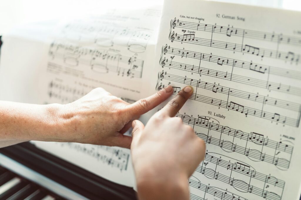 Persons Pointing at a Musical Composition