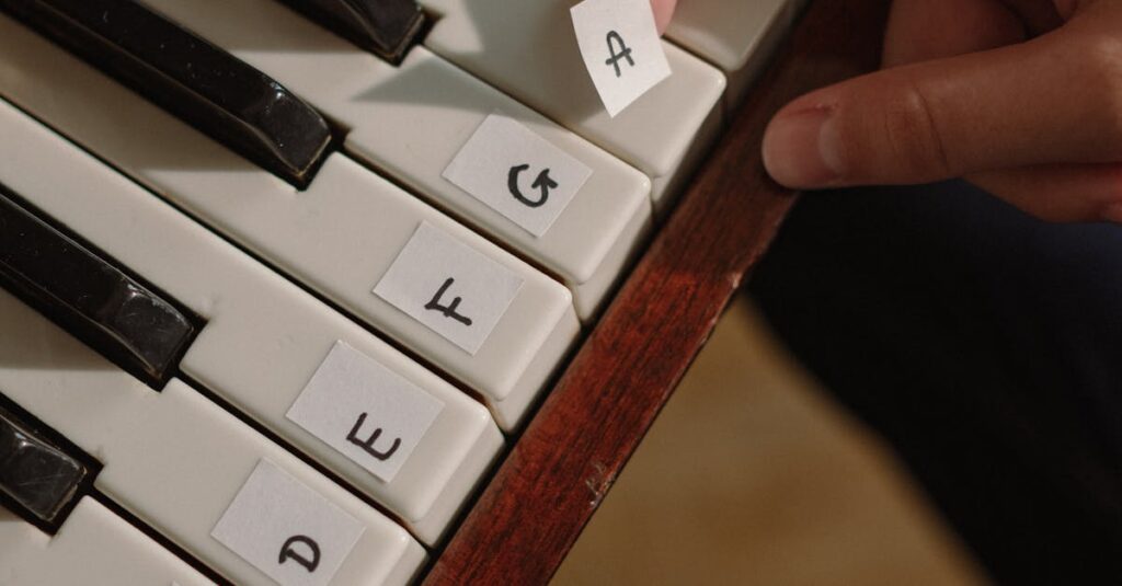 Close-up of fingers arranging letters on a piano keyboard.