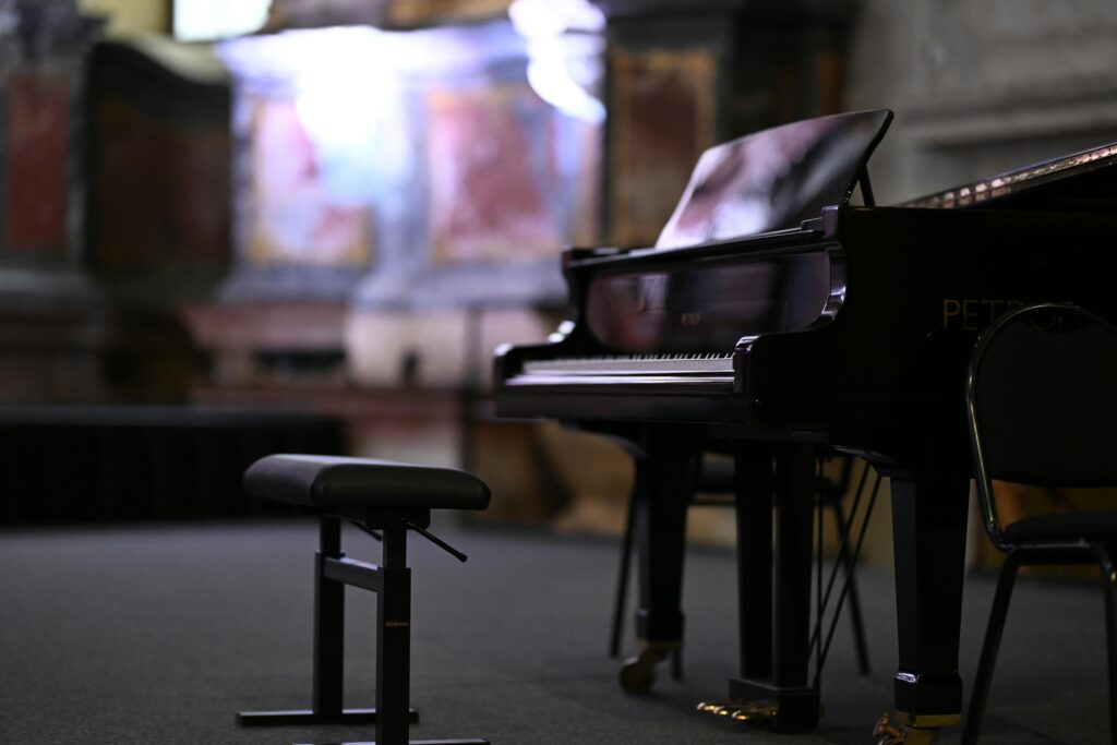 A beautiful grand piano in an ornate Vilnius concert hall setting, showcasing classic elegance.