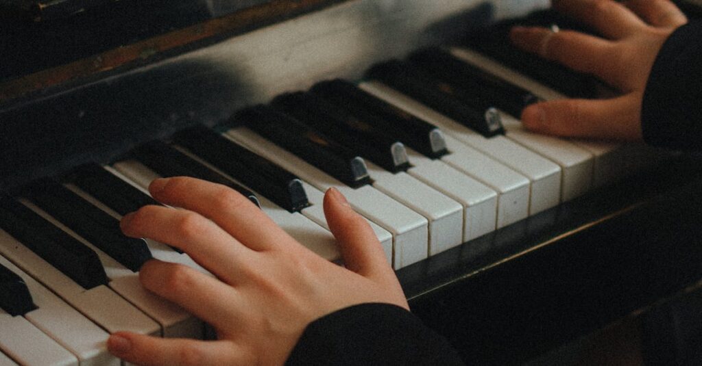 Hands playing piano with music sheet in view. Intimate and artistic setting.